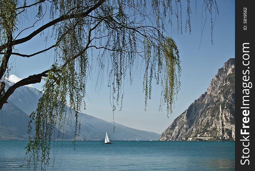 Lonely sailon a summer day - italy lake garda. Lonely sailon a summer day - italy lake garda