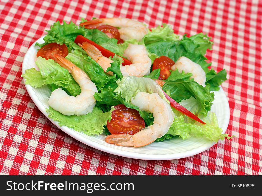 Shrimp salad with greens and tomatoes.