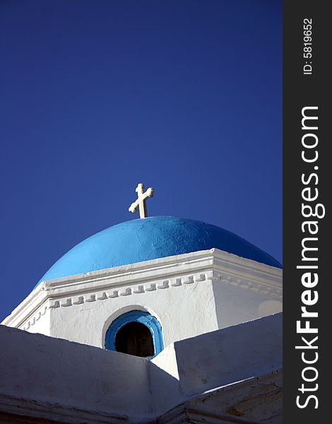 The top of a Greek Orthodox Church with a blue sky background. The top of a Greek Orthodox Church with a blue sky background.