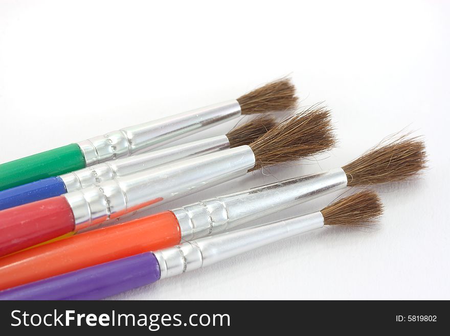 A set of children's paint brushes on a white background. A set of children's paint brushes on a white background.