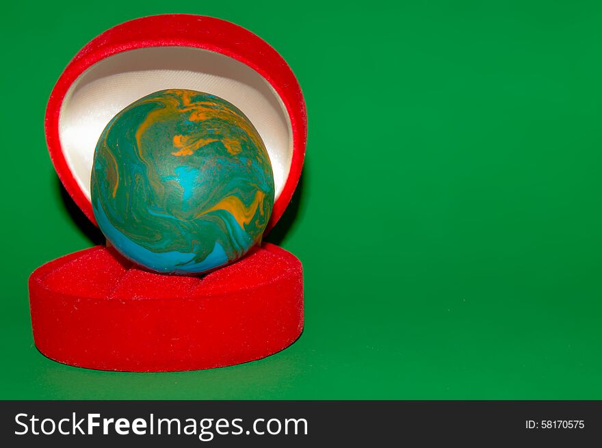 Earth style polymer clay ball in red jewelry box. Earth style polymer clay ball in red jewelry box