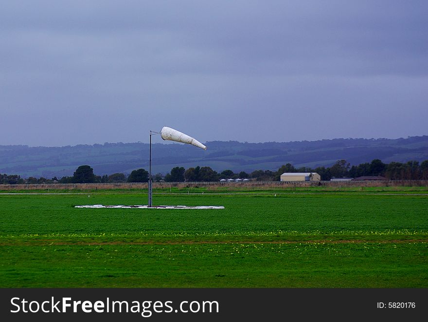 Photograph of a windsock at Aldinga Aerodrome on a very stormy day - no aircraft were flying because of the hazardous weather conditions (South Australia). Photograph of a windsock at Aldinga Aerodrome on a very stormy day - no aircraft were flying because of the hazardous weather conditions (South Australia).