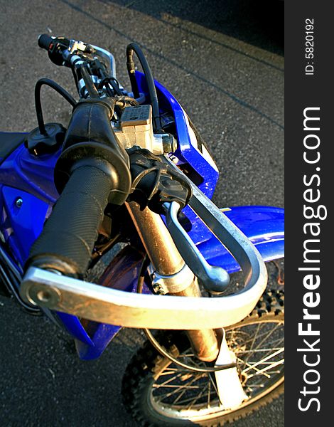 Brake handle /brush guard on blue dirt bike. Brake handle /brush guard on blue dirt bike