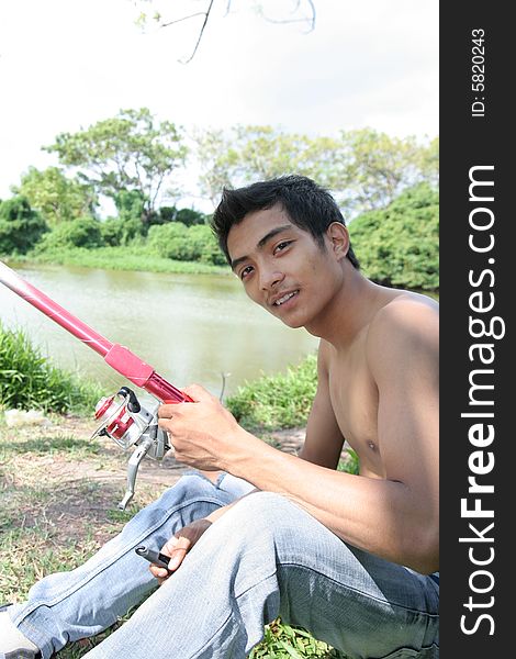 Young man fishing, hobby activity at weekend
