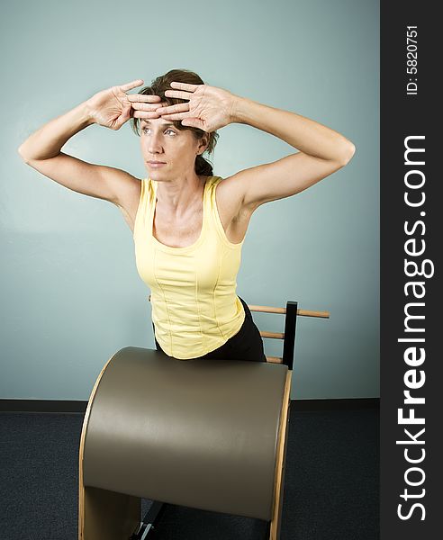 Athletic Woman Exercising and Stretching on Gym Equipment