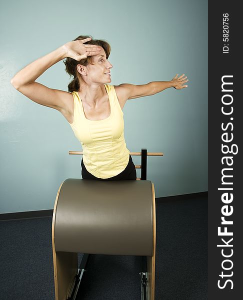 Athletic Woman Exercising and Stretching on Gym Equipment