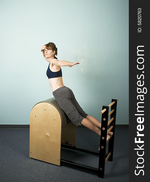 Athletic Woman Exercising and Stretching on Gym Equipment