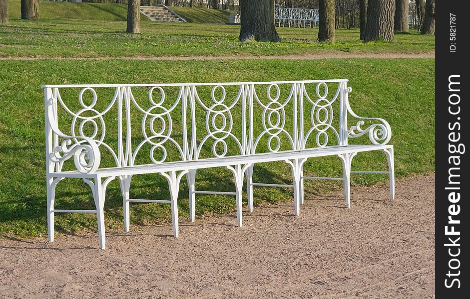 Laced metal bench in a park lane, town of Pushkin, Russia. Laced metal bench in a park lane, town of Pushkin, Russia