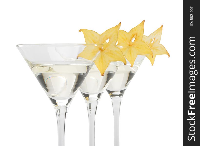 Glass of martini and slice of carambola on a white background. Glass of martini and slice of carambola on a white background