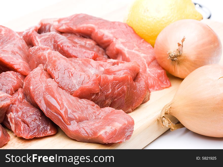 Fresh meat with vegetables on a white background. Close up.