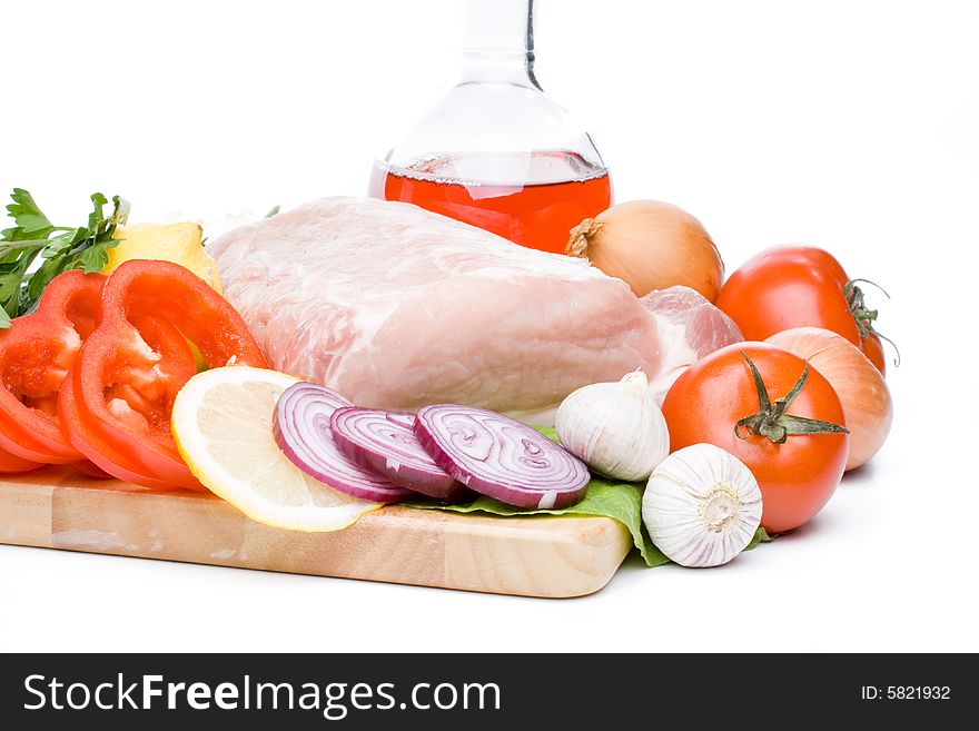 Fresh meat with vegetables on a white background. Close up.