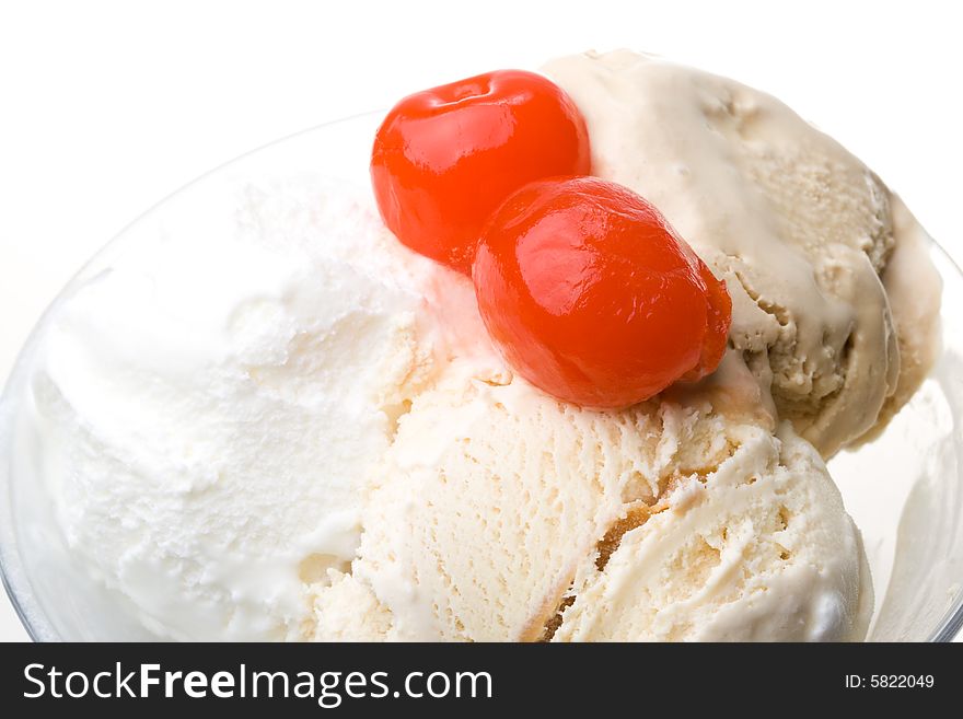 Ice-cream with a cherry in a glass on a white background. Ice-cream with a cherry in a glass on a white background.