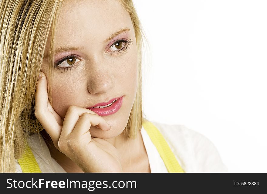 A portrait of a beautiful blond Caucasian young girl (15-24) looking at the copy space on white background, model release. A portrait of a beautiful blond Caucasian young girl (15-24) looking at the copy space on white background, model release.