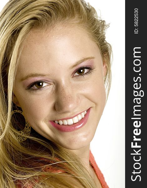 A portrait of a beautiful blond smiling Caucasian young girl (15-24) on white background, model release. A portrait of a beautiful blond smiling Caucasian young girl (15-24) on white background, model release.