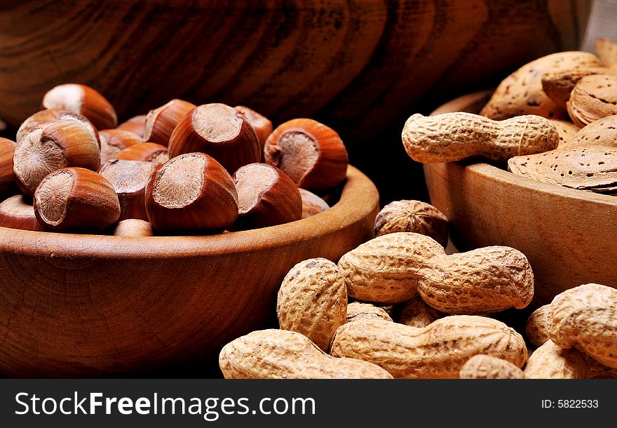 Mixed nuts in bowl on background