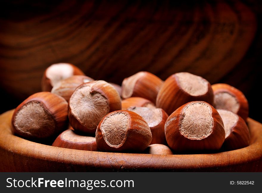 Bowl of hazelnuts on burlap background