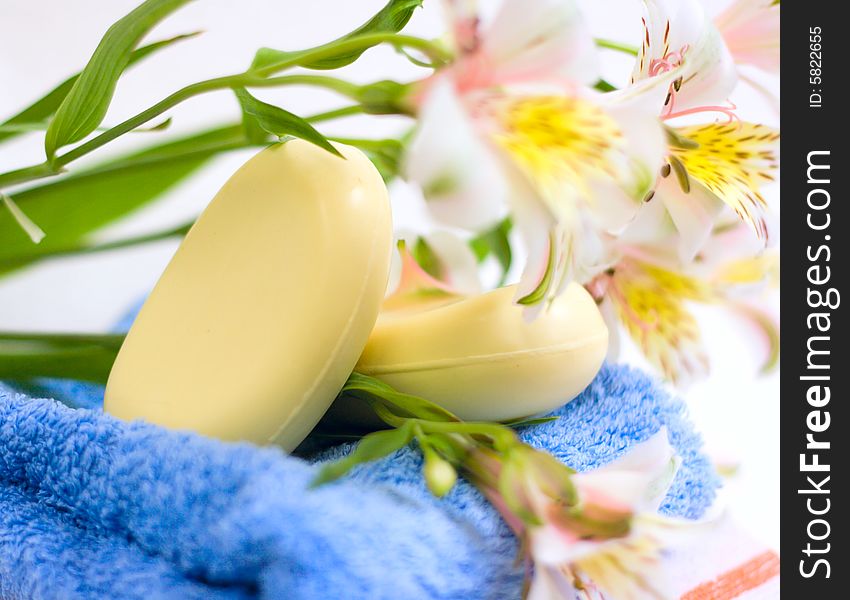 Soap and flower on blue fabric