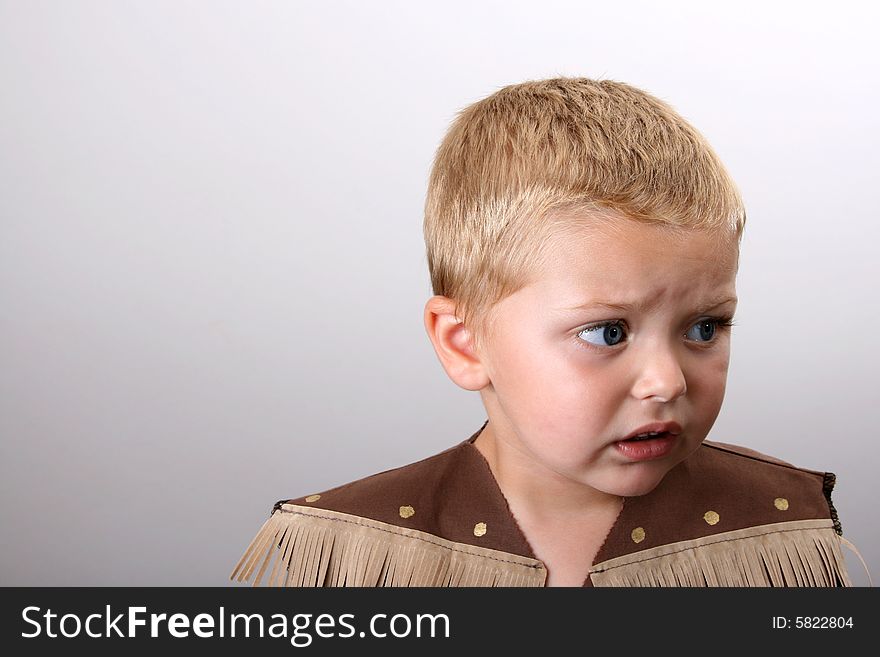 Toddler wearing a cowboy shirt with brown fringing