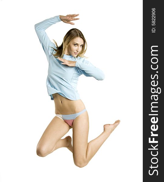 A beautiful blond athletic Caucasian young girl (18-26) in baby blue workout top and bikini underwear jumping with joy on white background, model release. A beautiful blond athletic Caucasian young girl (18-26) in baby blue workout top and bikini underwear jumping with joy on white background, model release.