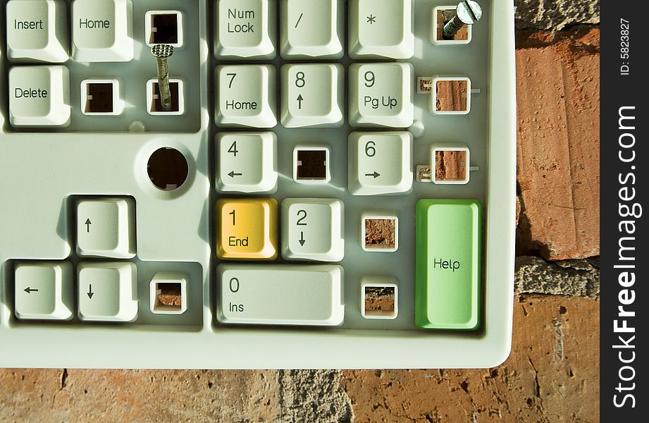 Disassembled keyboard with color button on the brick wall