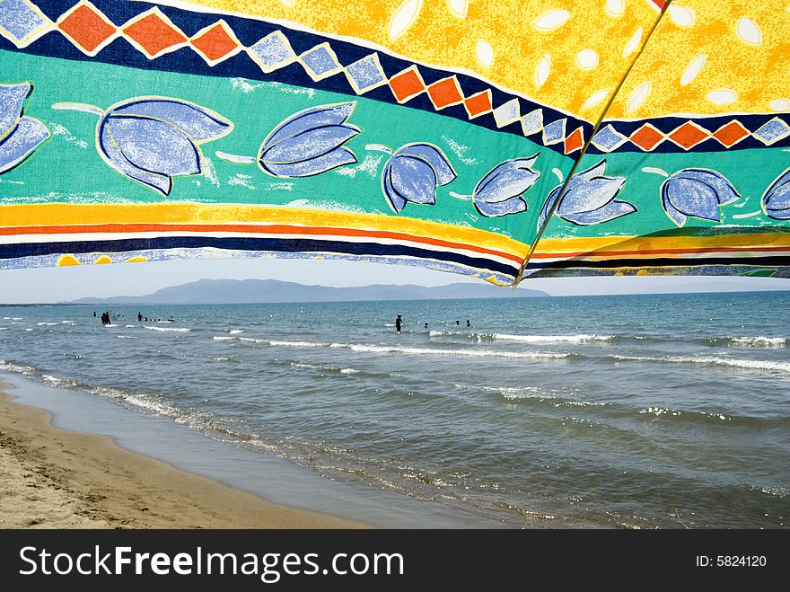 Sea scene seen from under a beach umbrella. Sea scene seen from under a beach umbrella