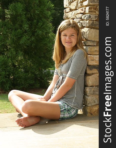 Teenage girl wearing a gray shirt and shorts