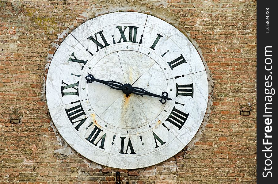 Huge ancient clock on red bricks wall. Huge ancient clock on red bricks wall