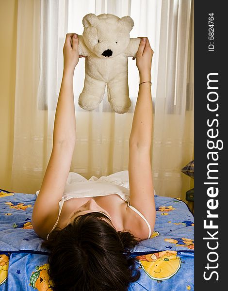 Young girl playing with her teddy bear. Young girl playing with her teddy bear.
