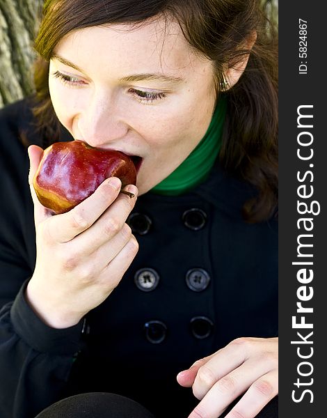 Young Woman Bitting An Apple