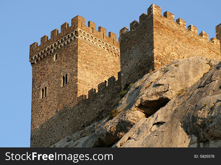 Ancient fortress on the rock on blue sky background