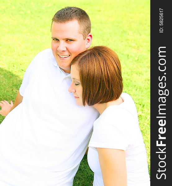 Happy couple embracing and playing in the park. concept for family and young people. Happy couple embracing and playing in the park. concept for family and young people