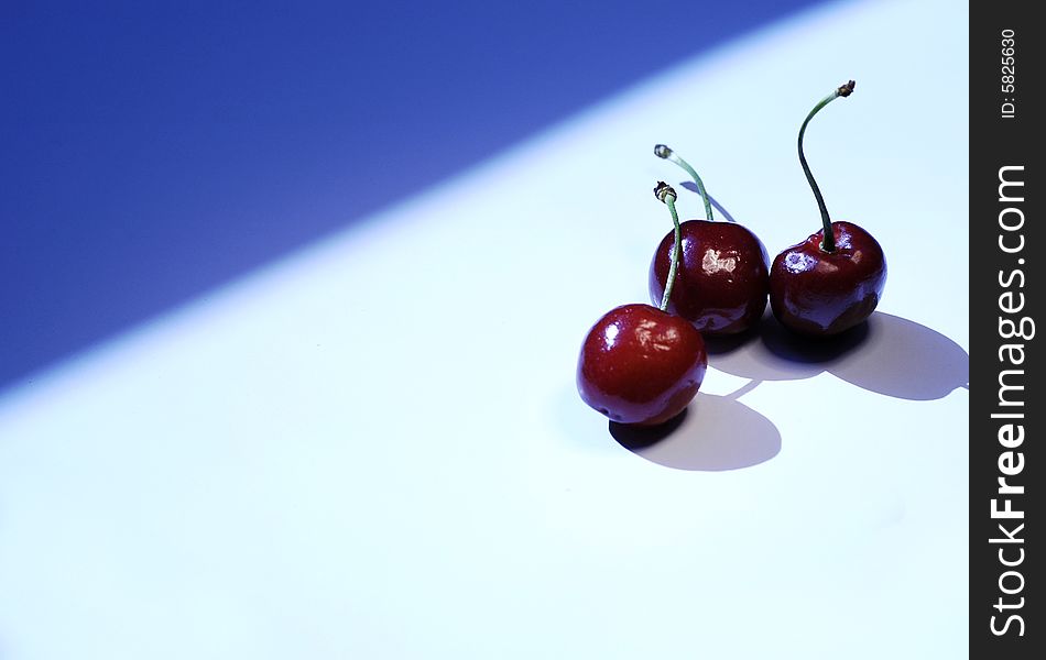 Photo of cherry on white and blue background