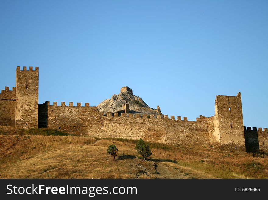 Ancient fortress on the rock on blue sky background