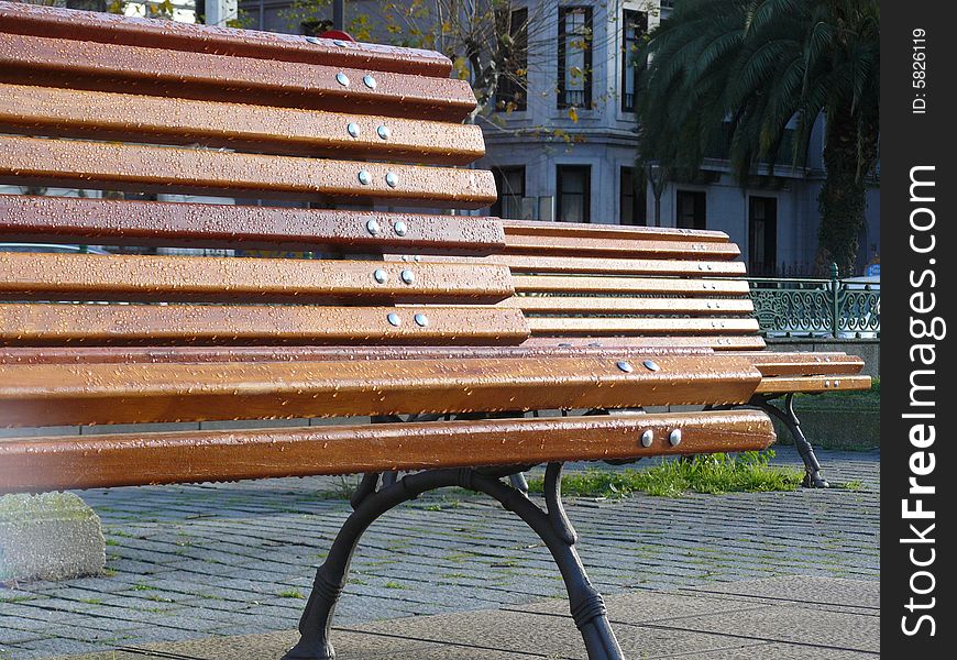 Two benches with dew in the city