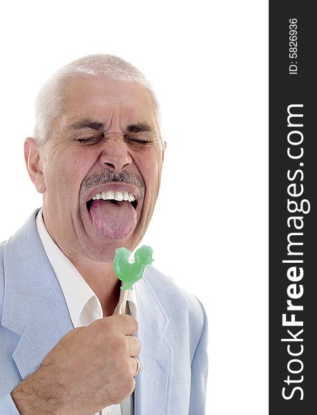 Senior man lick the green sweet candy. Senior man lick the green sweet candy