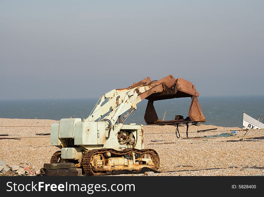 Dungeness, United Kingdom, Old Rusted Rotting Tractor in the sea side desert. Dungeness, United Kingdom, Old Rusted Rotting Tractor in the sea side desert