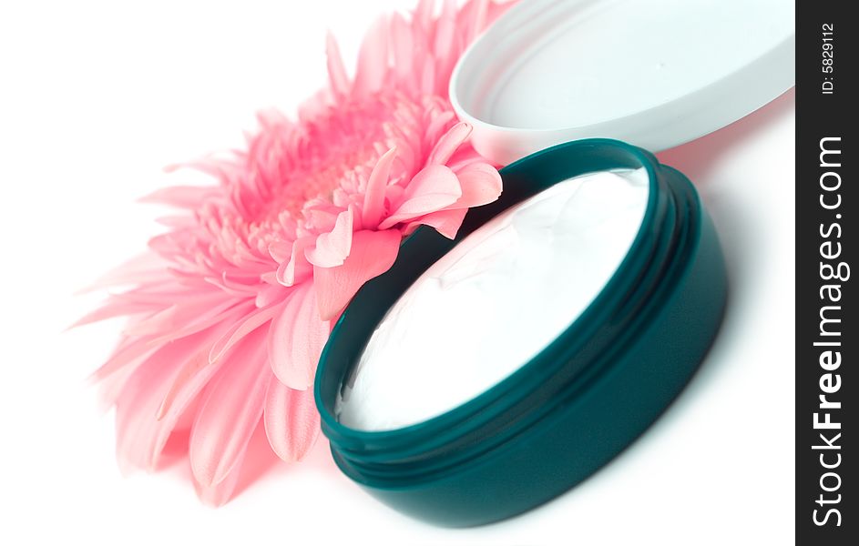 Moisturizing cream with pink gerbera close up