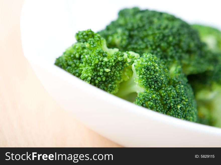 Fresh broccoli in white plate close up. Fresh broccoli in white plate close up