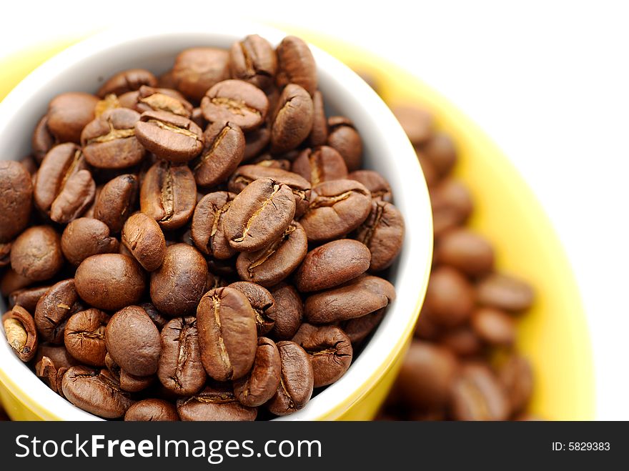 Cup  with roasted coffee beans. Cup  with roasted coffee beans