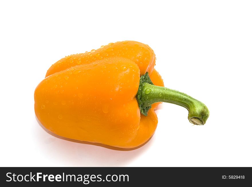 Wet orange bell pepper isolated on white