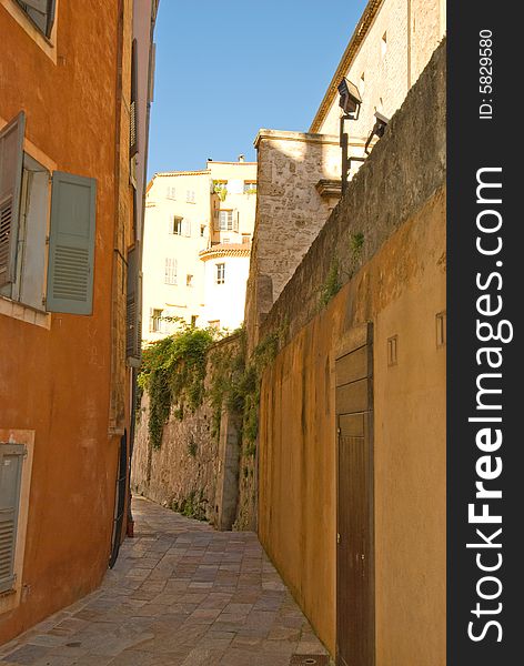 Colorful alley with stone walls and ancient pavement. Colorful alley with stone walls and ancient pavement