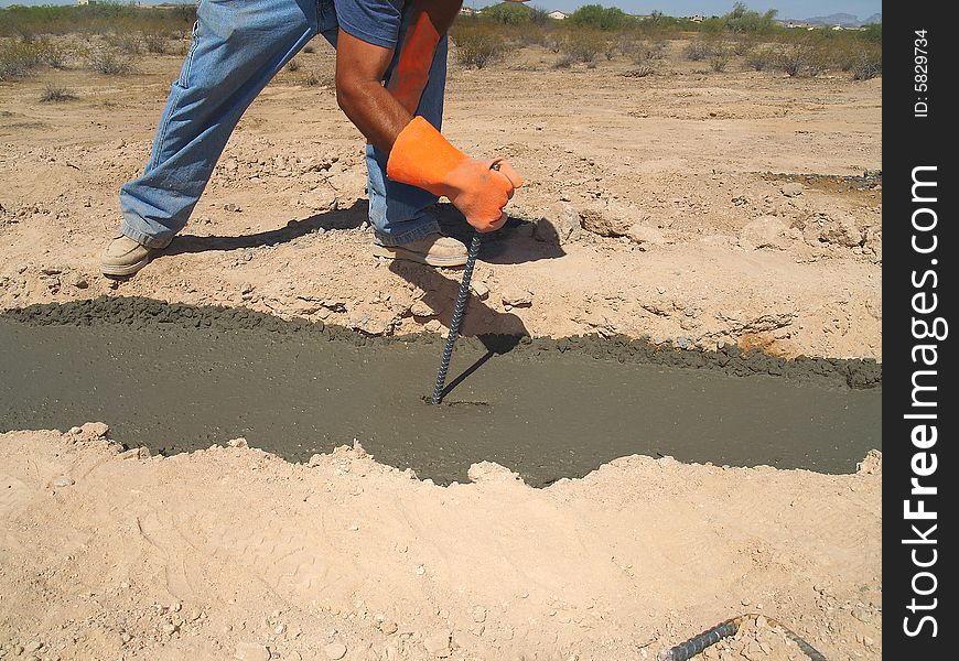 Man Digging Dirt On Excavation Site - Horizontal