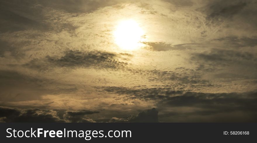 Strange sun behind the clouds