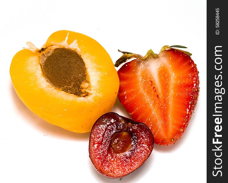Fresh ripe apricot, cherry and strawberry close up background.