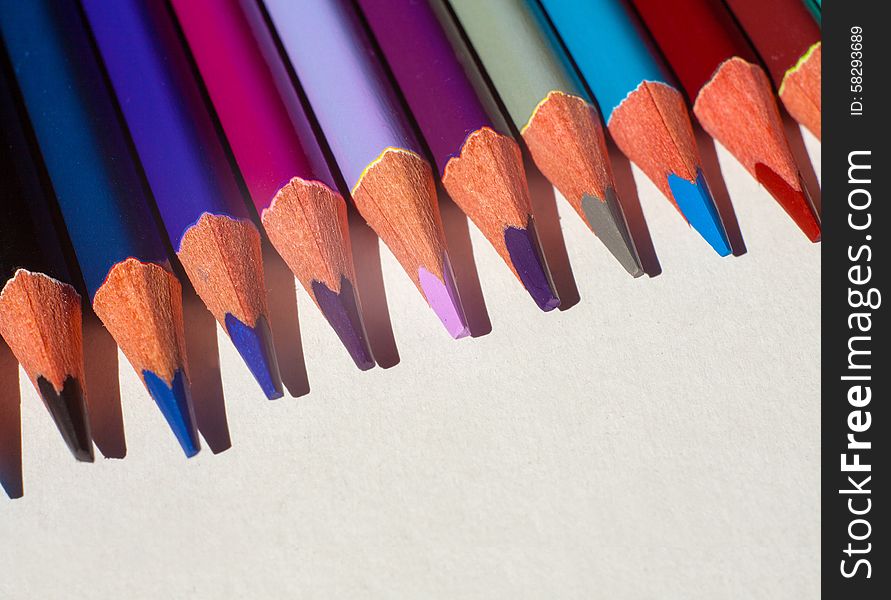 Colored pencils closeup on light background