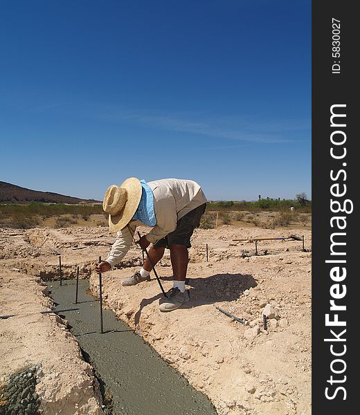 A man is working on an excavation site. Vertically framed shot. A man is working on an excavation site. Vertically framed shot.