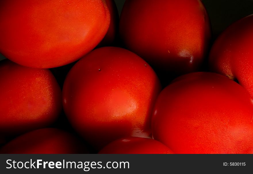 A close image of a group of tomatoes. A close image of a group of tomatoes