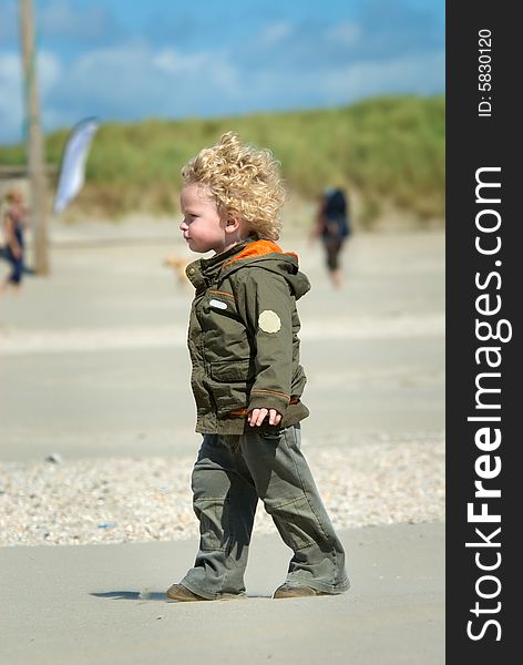 Cute young boy walking on the beach