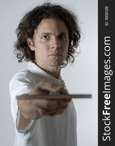 Man looks angry as he holds a table tennis paddle out in front of him. Vertically framed photograph. Man looks angry as he holds a table tennis paddle out in front of him. Vertically framed photograph