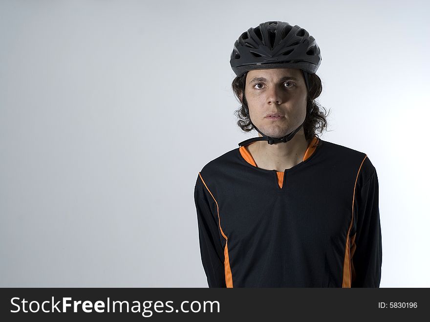 Man wearing a helmet has a serious expression on his face. Horizontally framed photograph. Man wearing a helmet has a serious expression on his face. Horizontally framed photograph